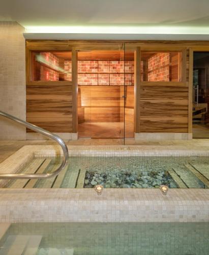 a swimming pool in a house with a glass door at Ovindoli Park Hotel & SPA in Ovindoli