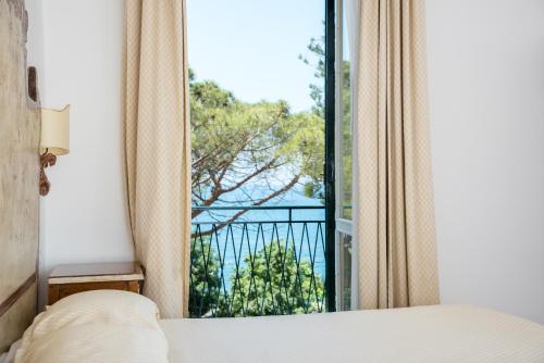 a bedroom with a bed and a window with a view at Relais San Giacomo in Maiori