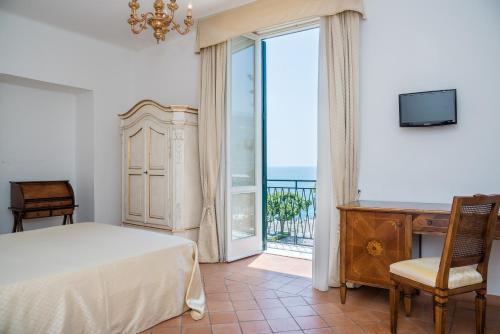 a bedroom with a bed and a view of the ocean at Relais San Giacomo in Maiori