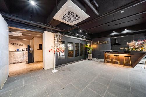 a large room with a bar in a building at Hotel 24st Prestige in Seosan