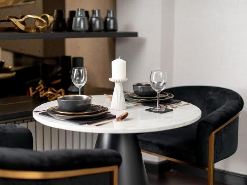 a table with two chairs and a white table with glasses at Luxury City Centre Oasis - Lux Spa Bath - Romantic in Edinburgh