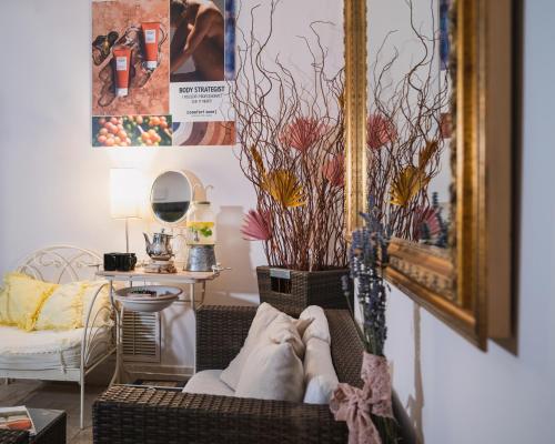 a living room with a couch and a vase with flowers at Ovindoli Park Hotel & SPA in Ovindoli