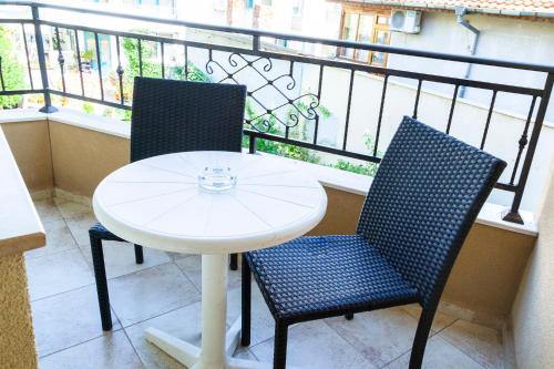 a white table and two chairs on a balcony at Ravda Bay Guest House in Ravda