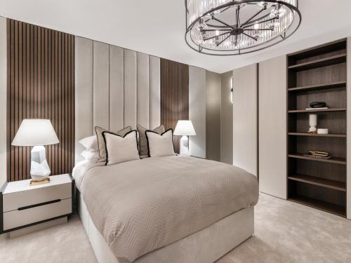a bedroom with a large bed and a chandelier at Luxury City Centre Oasis - Lux Spa Bath - Romantic in Edinburgh