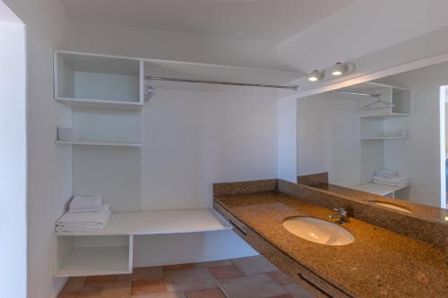 a bathroom with a sink and a mirror at Express Floripa Residence in Florianópolis