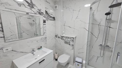 een badkamer met een toilet, een wastafel en een douche bij Nordic Residence 28 in Suceava