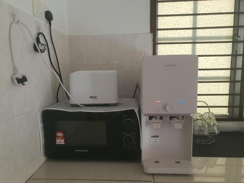two machines sitting next to each other in a room at Homey Homestay in Tanjong Sepat