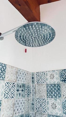 a bathroom with a tile floor with a knife at B&B Casale Pietrantica Tropea in Ciaramiti