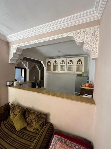 a living room with a couch and a kitchen at Villa Ms Holidays Mika privatisée Marrakech in Marrakech