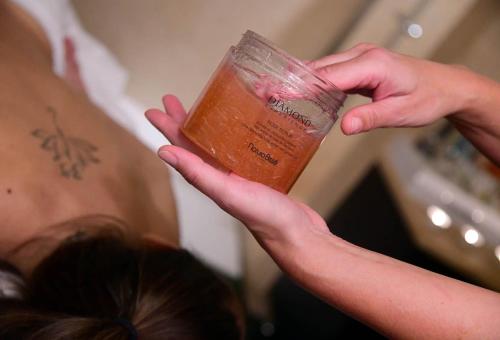 a person holding a cup of liquid in their hands at Mulino Luxury Boutique Hotel in Buje