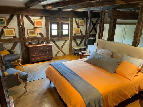 a bedroom with a bed and a desk and a chair at LE CLOS DU BENESTAR in Mauvezin-dʼArmagnac