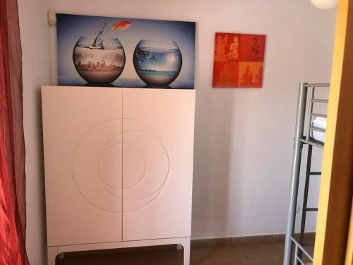 two vases are sitting on top of a shelf at Apartamento Altafulla in Altafulla