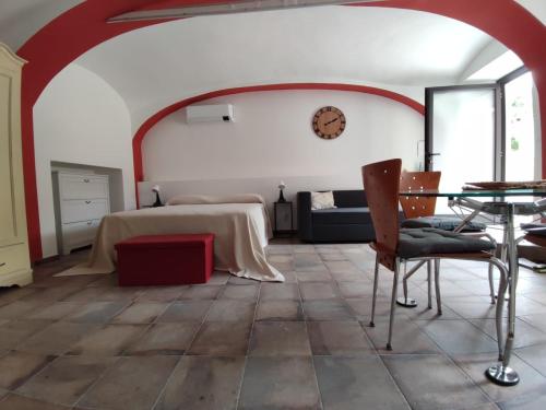 a room with a bed and a table and chairs at Ninsòle in La Morra