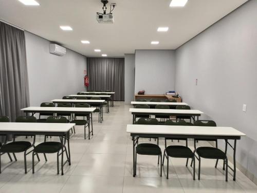 a row of tables and chairs in a room at HOTEL VIZON II in Vilhena