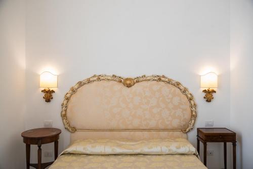 a bedroom with a bed with two side tables at Relais San Giacomo in Maiori