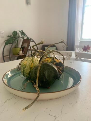 a plate with a bunch of gourds on a table at Forst-Ház Apartman in Eger