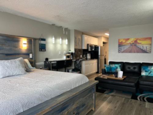 a bedroom with a bed and a living room at Sunrise Pool King Bed in Daytona Beach