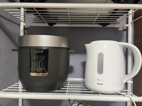 a toaster and a coffee pot on a shelf at えん吉野絶景広がる隠れ家1棟貸切ペットokサウナ室完備 in Yoshino