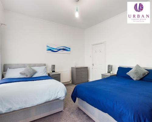 two beds sitting next to each other in a bedroom at 4 Bedroom House, Perfect For Business , Relocation, Contractors, Families By Urban Luxury Stays Short Lets & Serviced Accommodation Liverpool & Free Parking in Liverpool