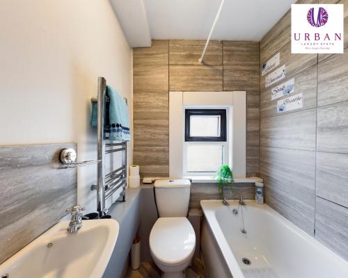 a bathroom with a toilet and a tub and a sink at 4 Bedroom House, Perfect For Business , Relocation, Contractors, Families By Urban Luxury Stays Short Lets & Serviced Accommodation Liverpool & Free Parking in Liverpool