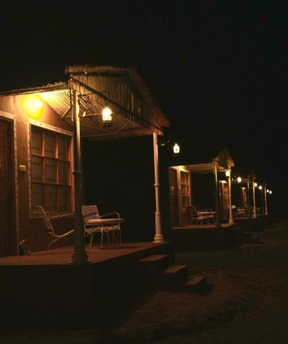 a house with a table and chairs at night at Bikaner Desert Camp and Resort in Bikaner