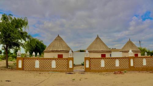 a building with three towers on top of it at Bikaner Desert Camp and Resort in Bikaner