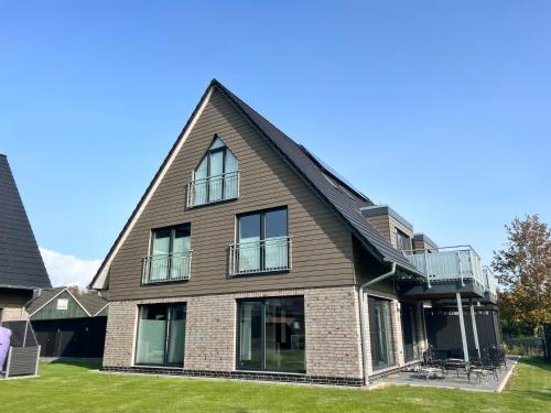 a large house with a gambrel roof at Lagertha - Maisonette in Büsum