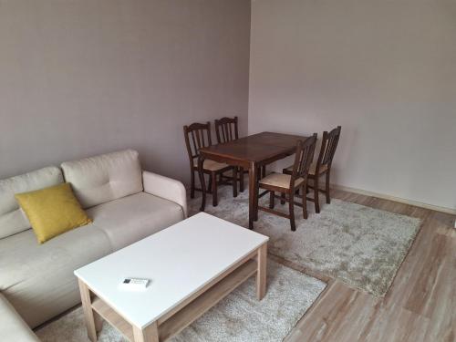 a living room with a couch and a table and chairs at Sarajevska Beograd in Sajmište