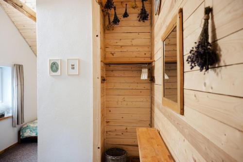 a staircase in a tiny house with wood paneling at ŽOLIŲ NAMELIS in Antalkiai