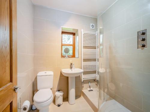 a bathroom with a white toilet and a sink at South Steading in Seamill