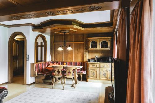 a kitchen with a table and chairs in a room at Landhaus Perktold in Nesselwängle