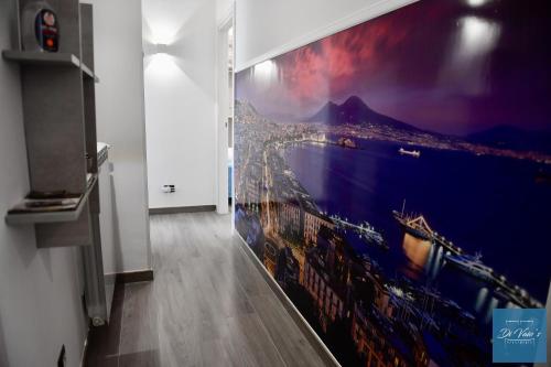 un grande dipinto su un muro in una stanza di Di Vaio’s Apartments a Napoli