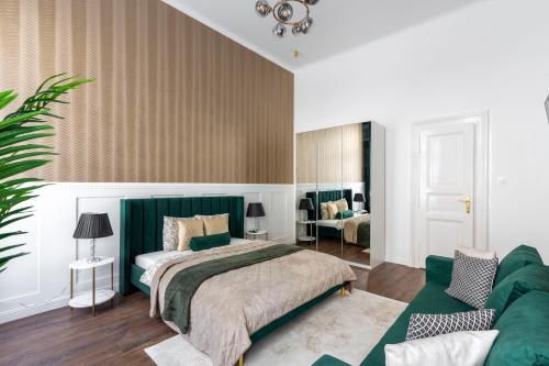 a bedroom with a bed and a couch at Luxurious Prestige Residence next to the New York Café in Budapest