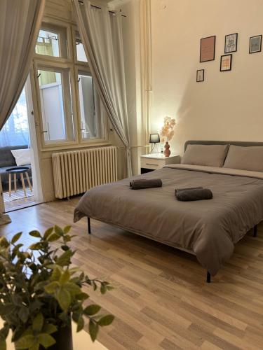 a bedroom with a bed with two pillows on it at Central Park Apartment in Novi Sad