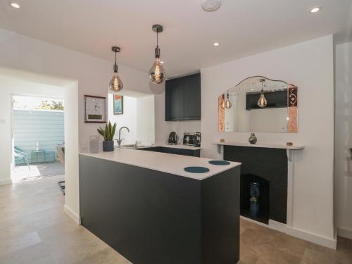 a kitchen with a island in the middle of a room at Mollys Cottage in Dorchester