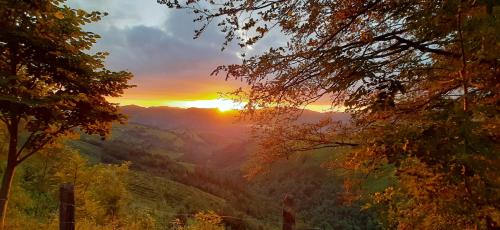 a view of the sun setting over a valley at Ondarbaso Apartamentos Rurales III in Zestoa