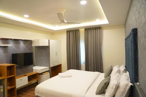 a hotel room with a bed and a ceiling at Mevid Hotels in Hyderabad
