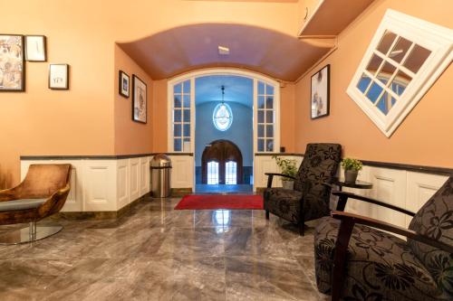 a room with a hallway with chairs and a door at City Hotell Avenyn in Gothenburg