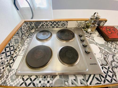 une cuisinière avec trois plaques au-dessus d'un comptoir dans l'établissement Maison centre village Soligny la Trappe proche Mortagne au perche - Sanateflo -, à Soligny-la-Trappe