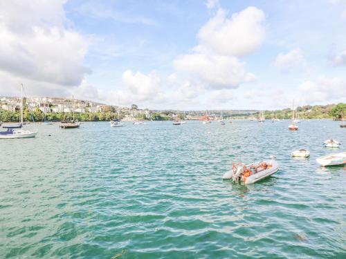 a group of people in a boat in the water at James' Place in Falmouth