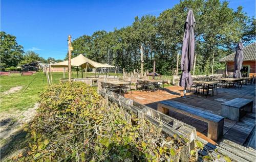 a patio with an umbrella and tables and chairs at Amazing Stacaravan In Hoogersmilde in Hoogersmilde