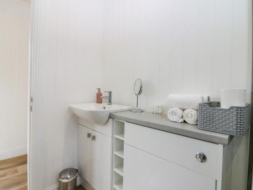 a bathroom with a sink and a counter with towels at Lodge 19 - Isla Hideaway in Perth