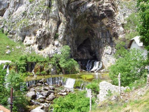 a waterfall in a cave in a mountain at Prenoćište San Rooms in Livno