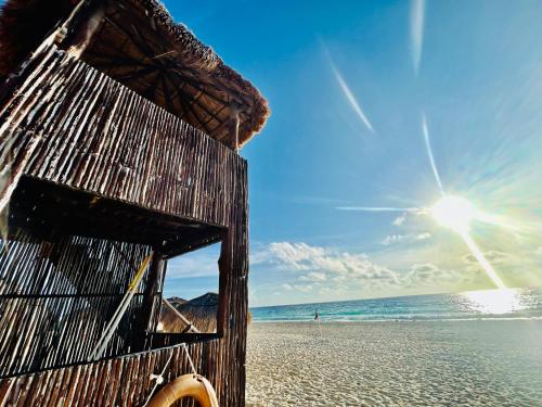 a beach with a wooden hut on the beach at Solymar Beach Condos in Cancún