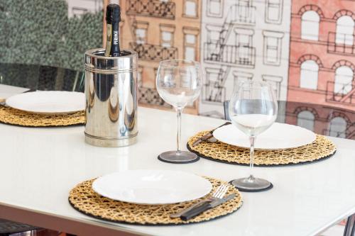a table with plates and wine glasses on it at Assago amazing flat in Assago