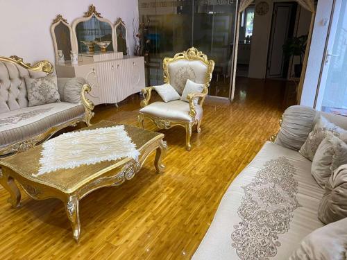 a living room with chairs and a couch and a table at Skopje Hostel in Skopje