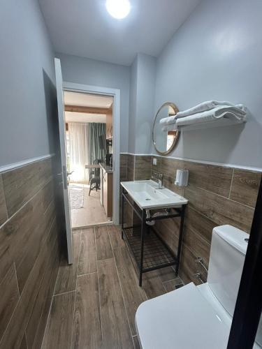 a bathroom with a sink and a toilet and a mirror at NarPera Taksim in Istanbul