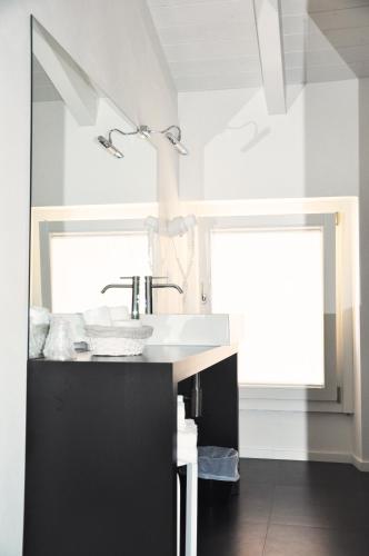 a bathroom with a sink and a mirror at Casa Fola - City Centre Rooms in Verona