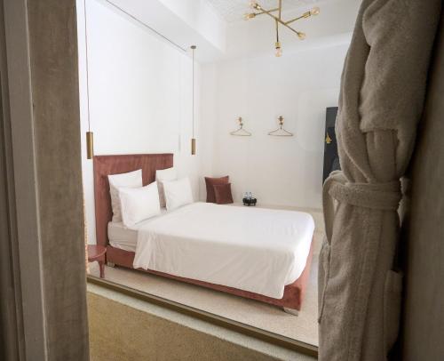 a bedroom with a bed and a large window at Numa Marrakech in Marrakech