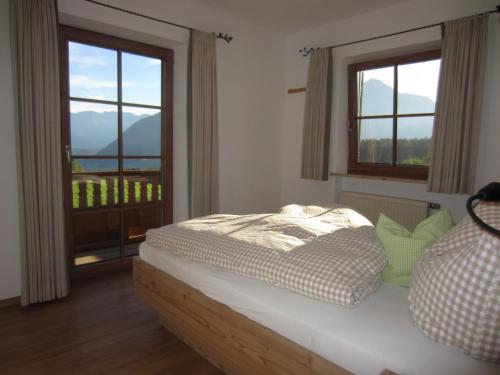 a bedroom with a bed and a window with a view at Kochhof in Piding